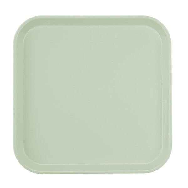 A square white tray with a green border.