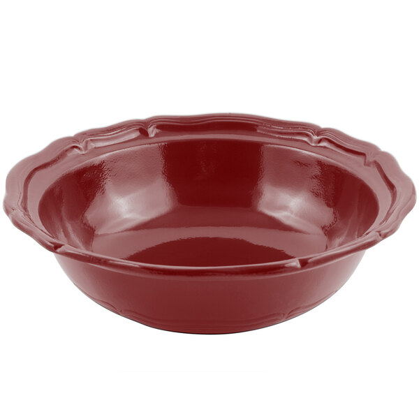 A red Bon Chef Queen Anne salad bowl with a scalloped edge.