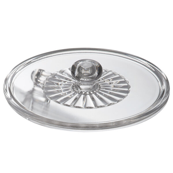 A clear glass lid with a round handle.