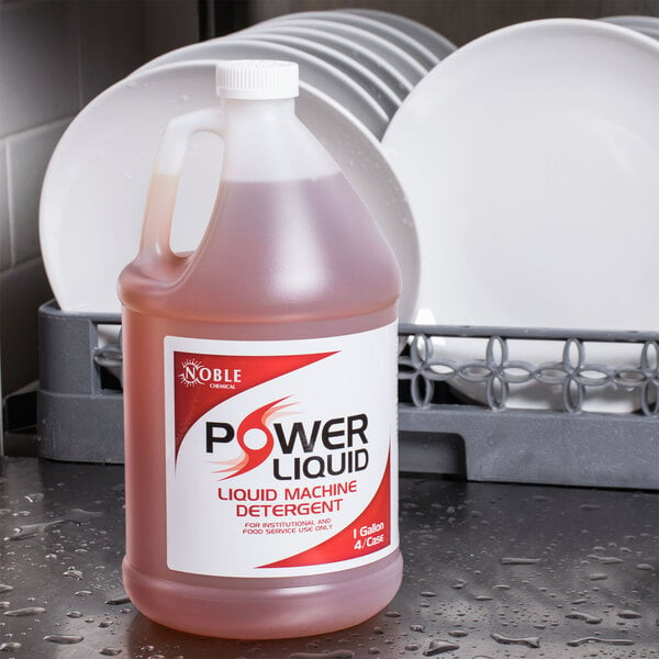 A red bottle of Noble Chemical Power Concentrated Liquid Dish Washing Machine Detergent next to a dishwasher.
