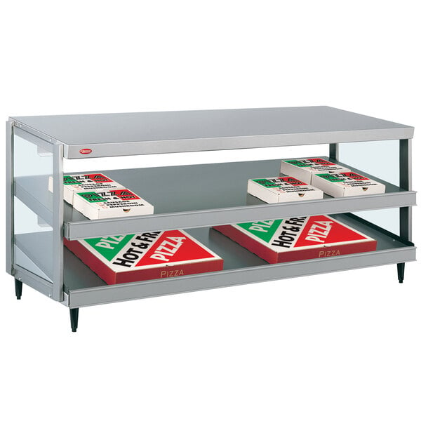 A Hatco countertop display shelf with pizza boxes inside.