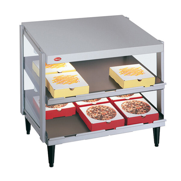 A Hatco countertop double shelf warmer with pizza boxes on the shelves.