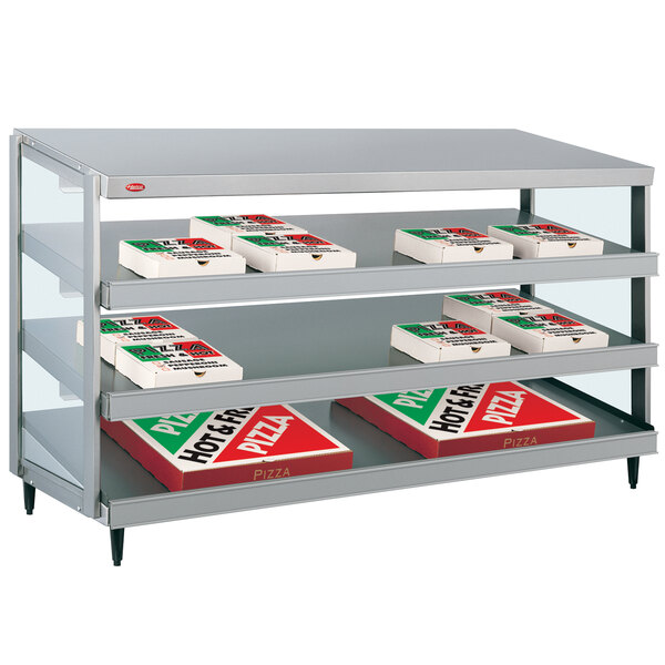 A Hatco countertop pizza warmer shelf with pizza boxes inside.