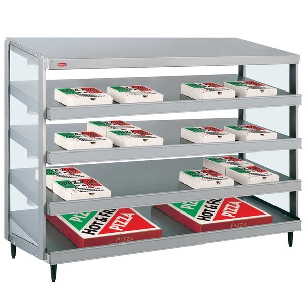 A Hatco countertop pizza warmer with shelves holding red and white pizza boxes.