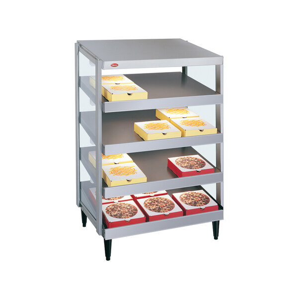 A Hatco pizza warmer with yellow and white shelves holding pizza boxes.
