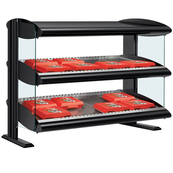 A black Hatco countertop display case with red shelves holding red boxes.