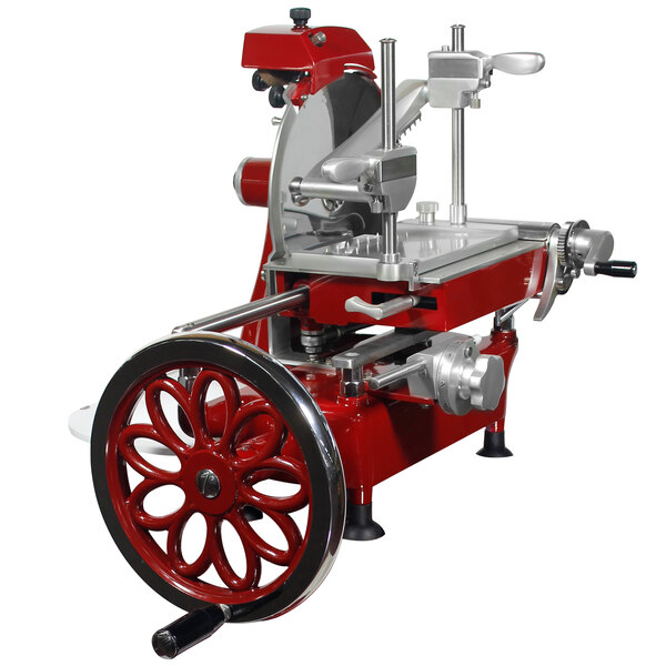 An Omcan red and silver manual meat slicer with flower wheel attachment.