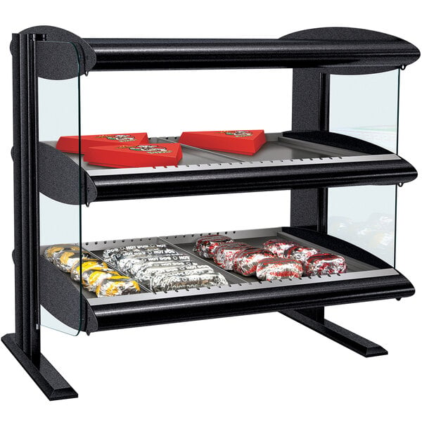 A black and silver Hatco countertop display case with food on shelves.