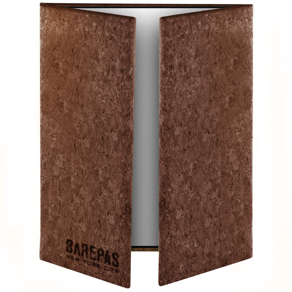 A brown rectangular cork menu cover with white custom text.