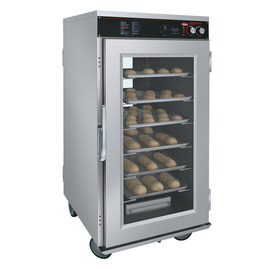 A Hatco stainless steel holding cabinet with trays of bread on shelves.