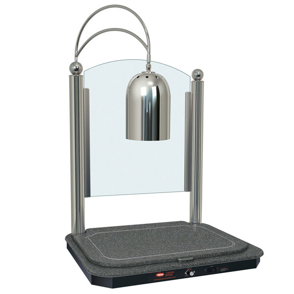A silver Hatco carving lamp on a stand with a night sky-colored heated base.