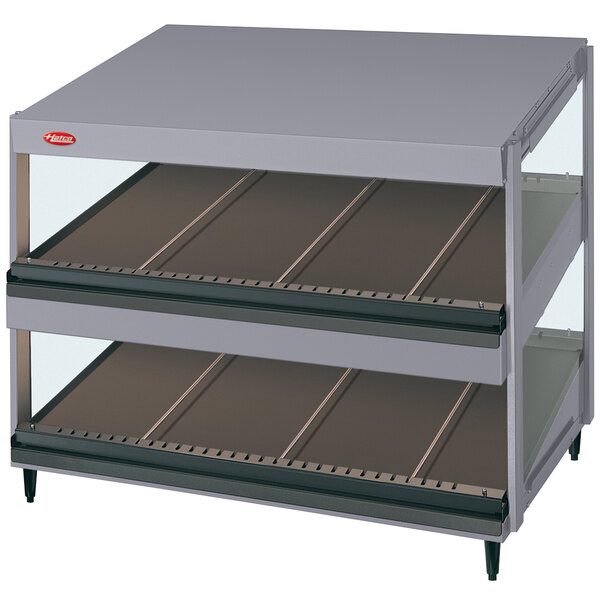 A grey Hatco countertop display with slanted glass shelves.