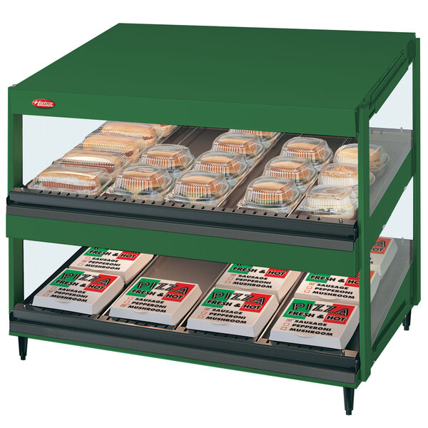 A Hunter Green Hatco food display case with food on shelves.