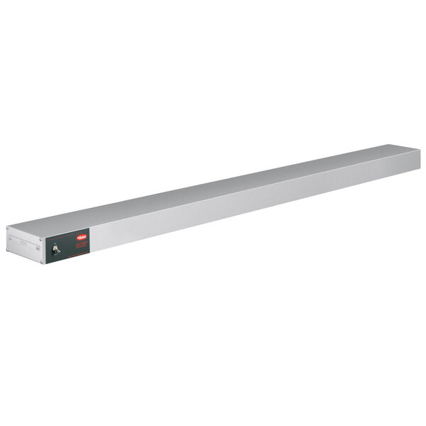 A long rectangular white metal shelf with a red light and a button on it.