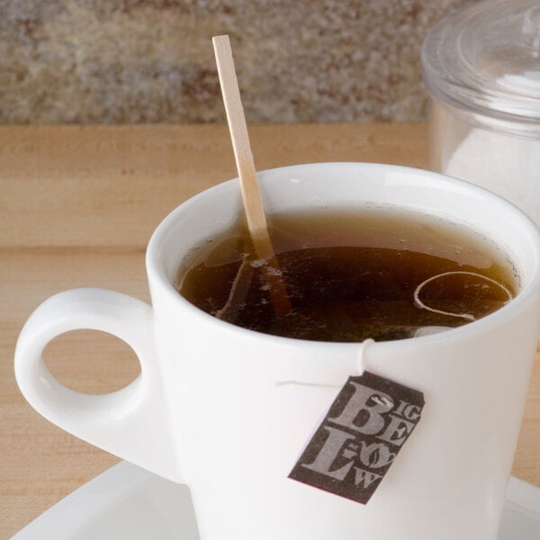 A cup of tea with a Royal Paper wood coffee stirrer in it.