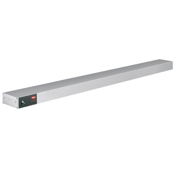 A long rectangular metal shelf with red infrared lights.