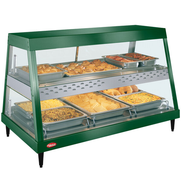 A Hatco Hunter green stainless steel food warmer display with trays of food.