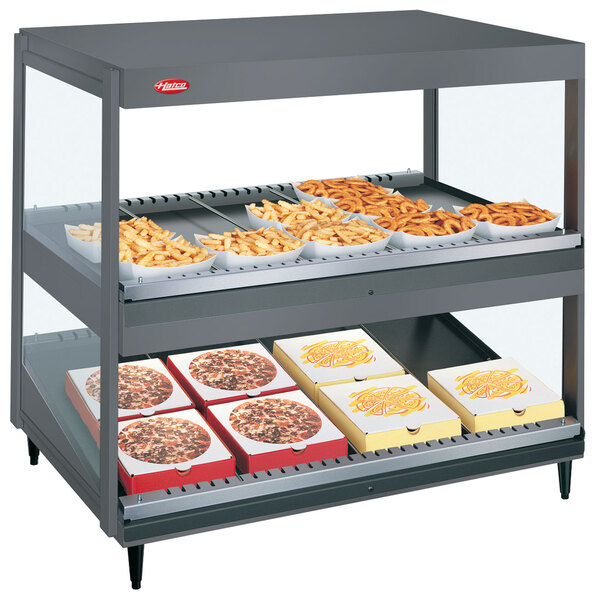 A Hatco countertop food display warmer with food trays on it.