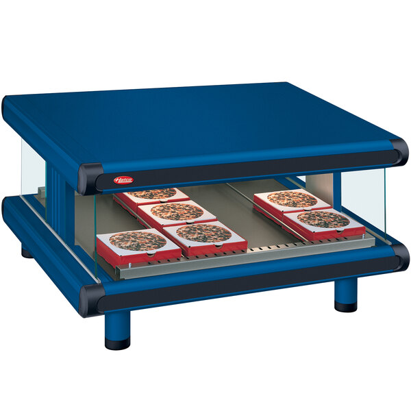 A blue Hatco countertop with pizzas on it.