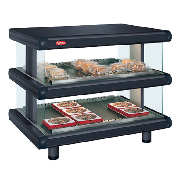 A black Hatco food warmer with glass shelves holding trays of food.