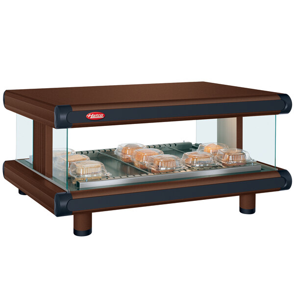 A brown Hatco countertop display case with food trays inside.