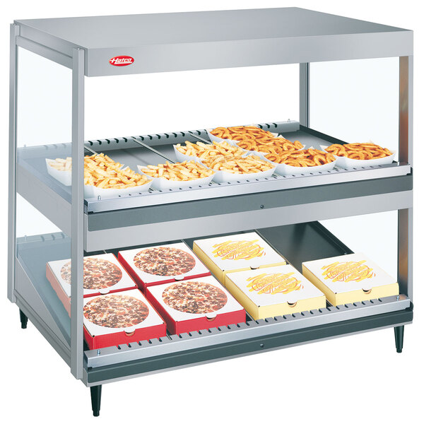 A Hatco countertop food warmer with food trays inside on display.