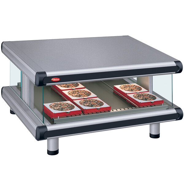 A Hatco countertop food warmer with trays of pizza on display.