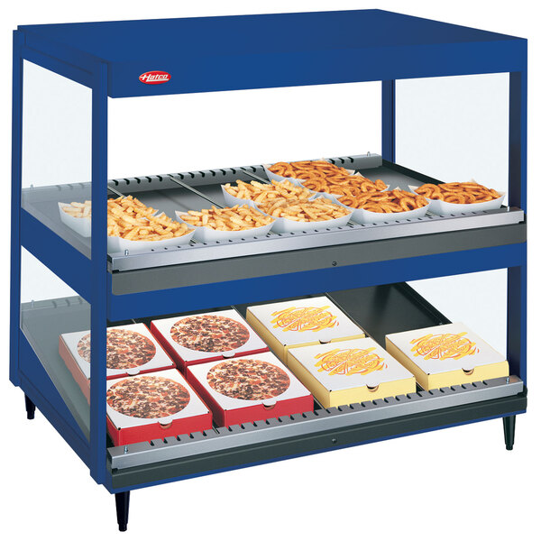 A blue Hatco countertop display with trays of food.
