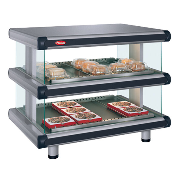 A Hatco gray granite double shelf food display case on a countertop with food in it.
