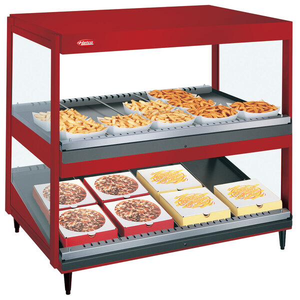 A red Hatco warm food display with trays of food on it.