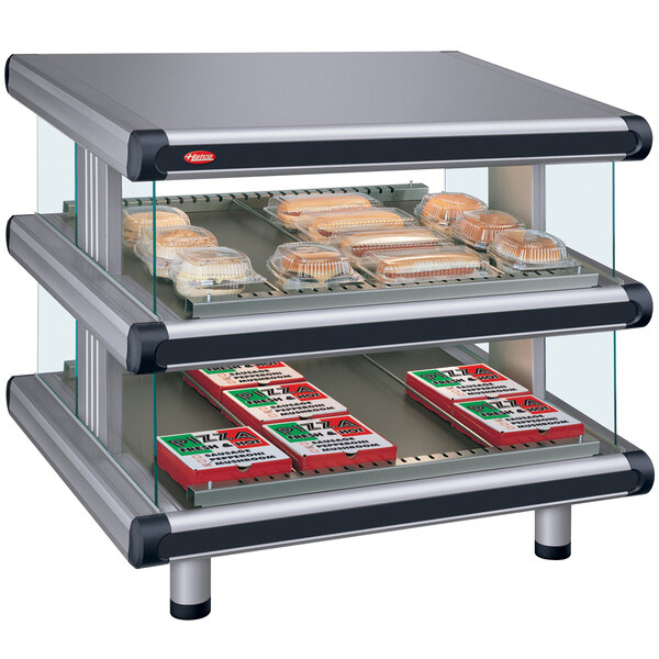 A Hatco granite countertop display case with food on two slanted shelves.