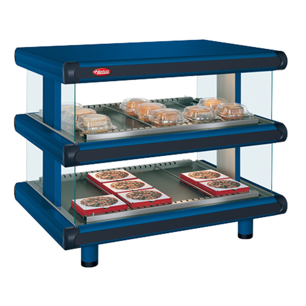 A navy blue Hatco countertop display case with two shelves holding trays of food.