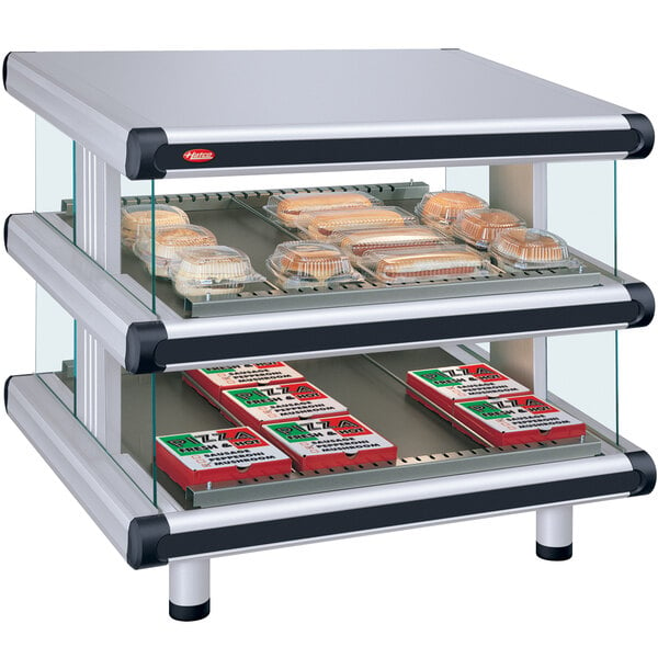A Hatco white granite slanted double shelf merchandiser with food displayed inside.