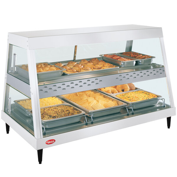 A Hatco countertop food warmer with trays of food in a display case.