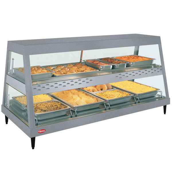 A Hatco countertop hot food display warmer with trays of food on it.