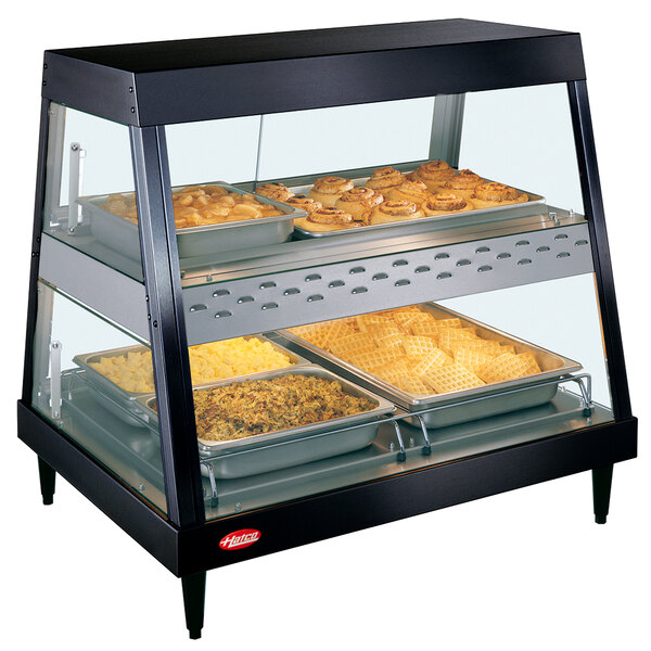 A Hatco countertop display case with food on shelves.