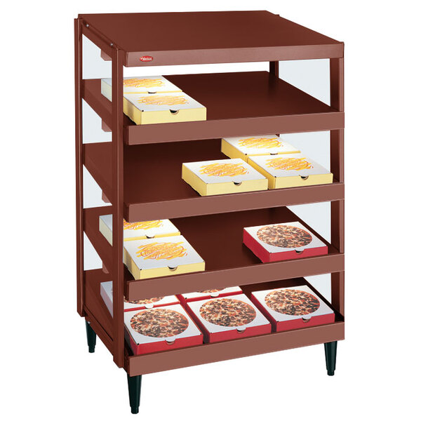 A Hatco Antique Copper pizza warmer with pizza boxes on shelves.