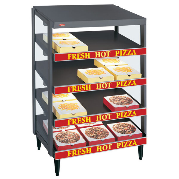 A Hatco granite gray countertop pizza warmer with pizza boxes on the shelves.
