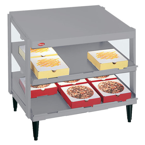 A Hatco Granite White double shelf pizza warmer with grey pizza boxes on it.
