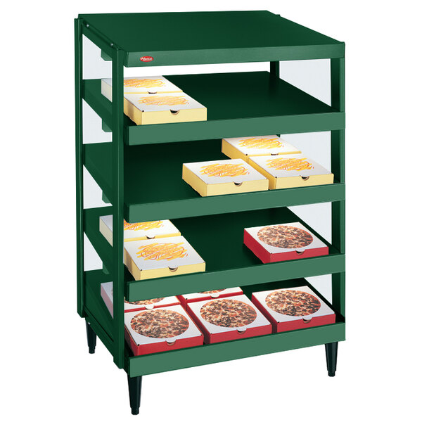 A Hunter green Hatco pizza warmer shelf with pizza boxes on it.