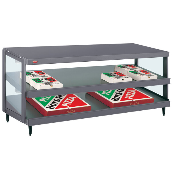 A grey Hatco countertop pizza warmer shelf with pizza boxes on it.