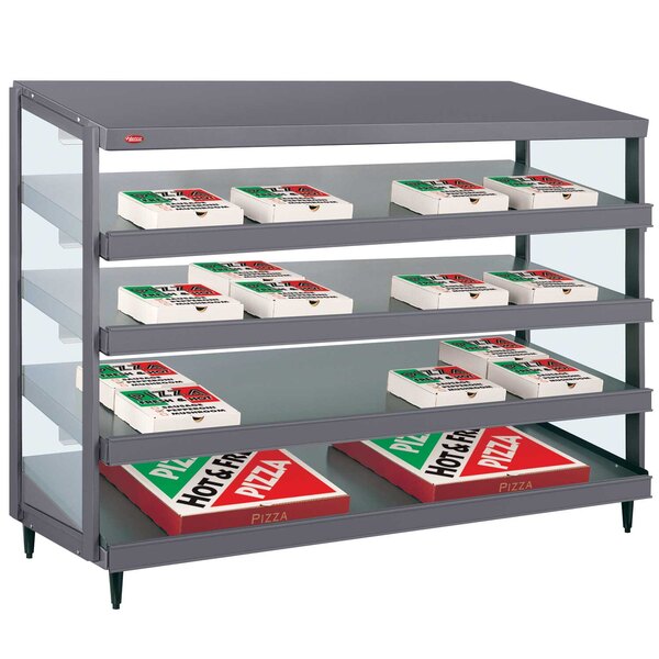 A Hatco Granite Gray Glo-Ray pizza warmer shelf holding pizza boxes in a bakery display.
