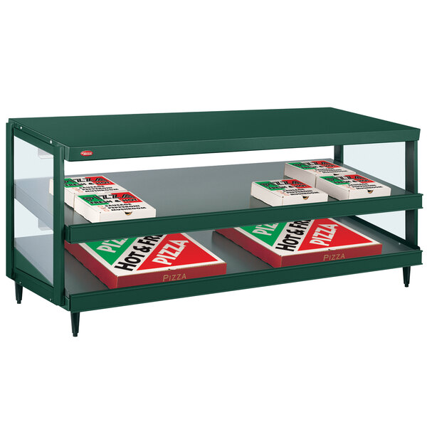 A Hatco Hunter Green Glo-Ray countertop shelf with pizza boxes on it.