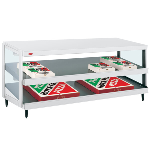 A white Hatco countertop display shelf with pizza boxes inside.