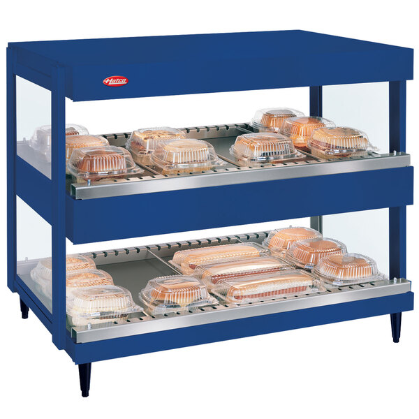 A blue Hatco countertop with trays of food.