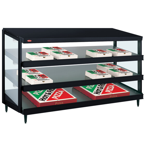 A black Hatco countertop display shelf with pizza boxes on it.