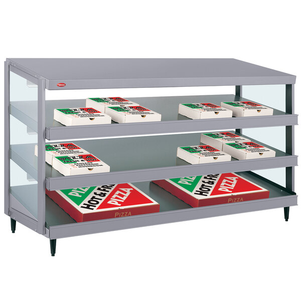 A Hatco countertop warmer shelf with pizza boxes on it.