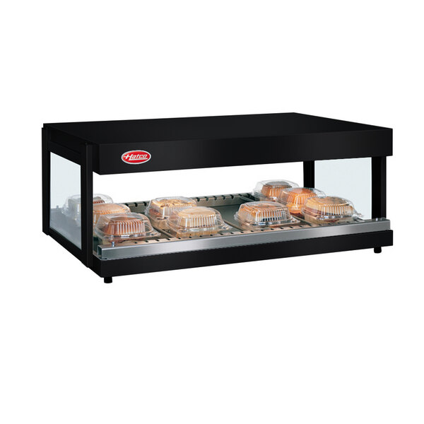 A black Hatco countertop food warmer with trays of food on a shelf.
