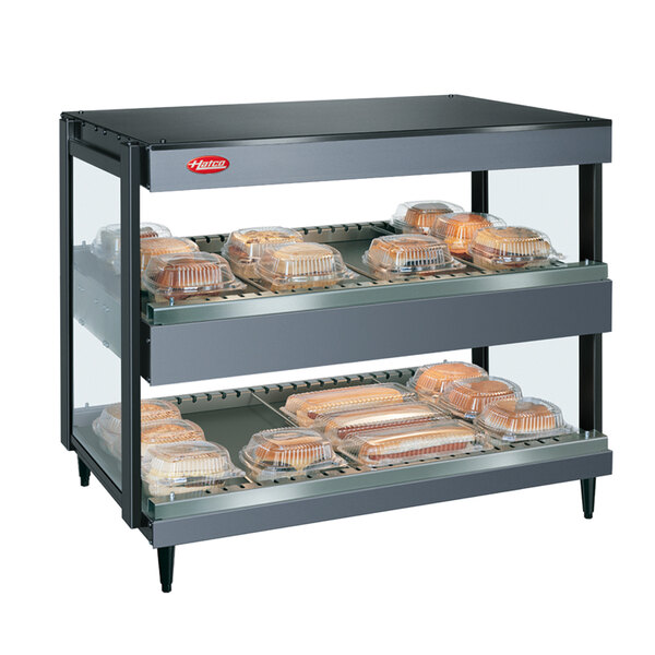 A Hatco gray granite countertop merchandiser with trays of food on shelves.