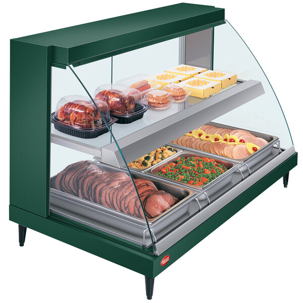 A green Hatco countertop food warmer with food on display in a bakery.